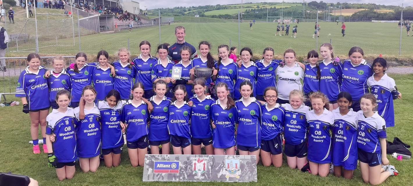 The school ladies football team with their trophy