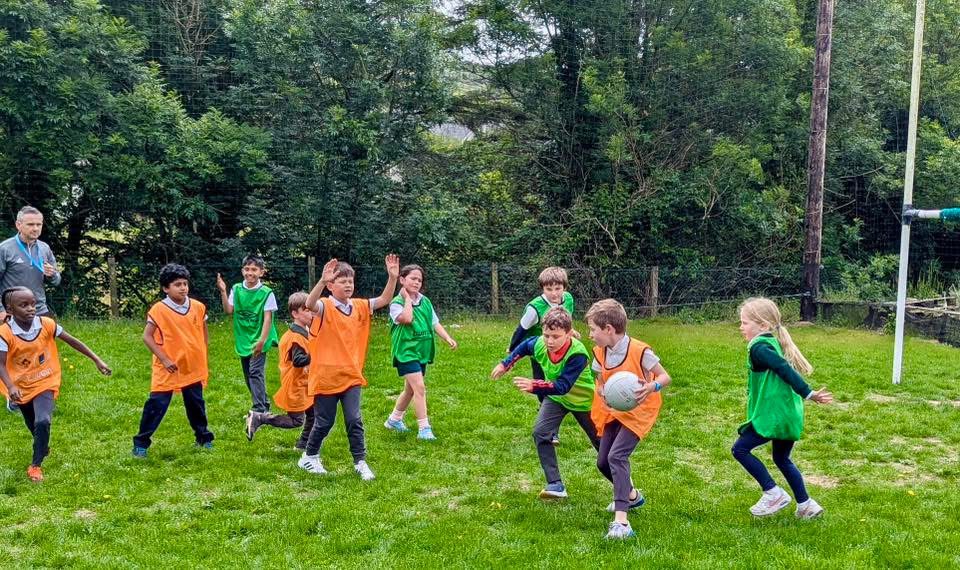 Pupils playing Gaelic football on the school field