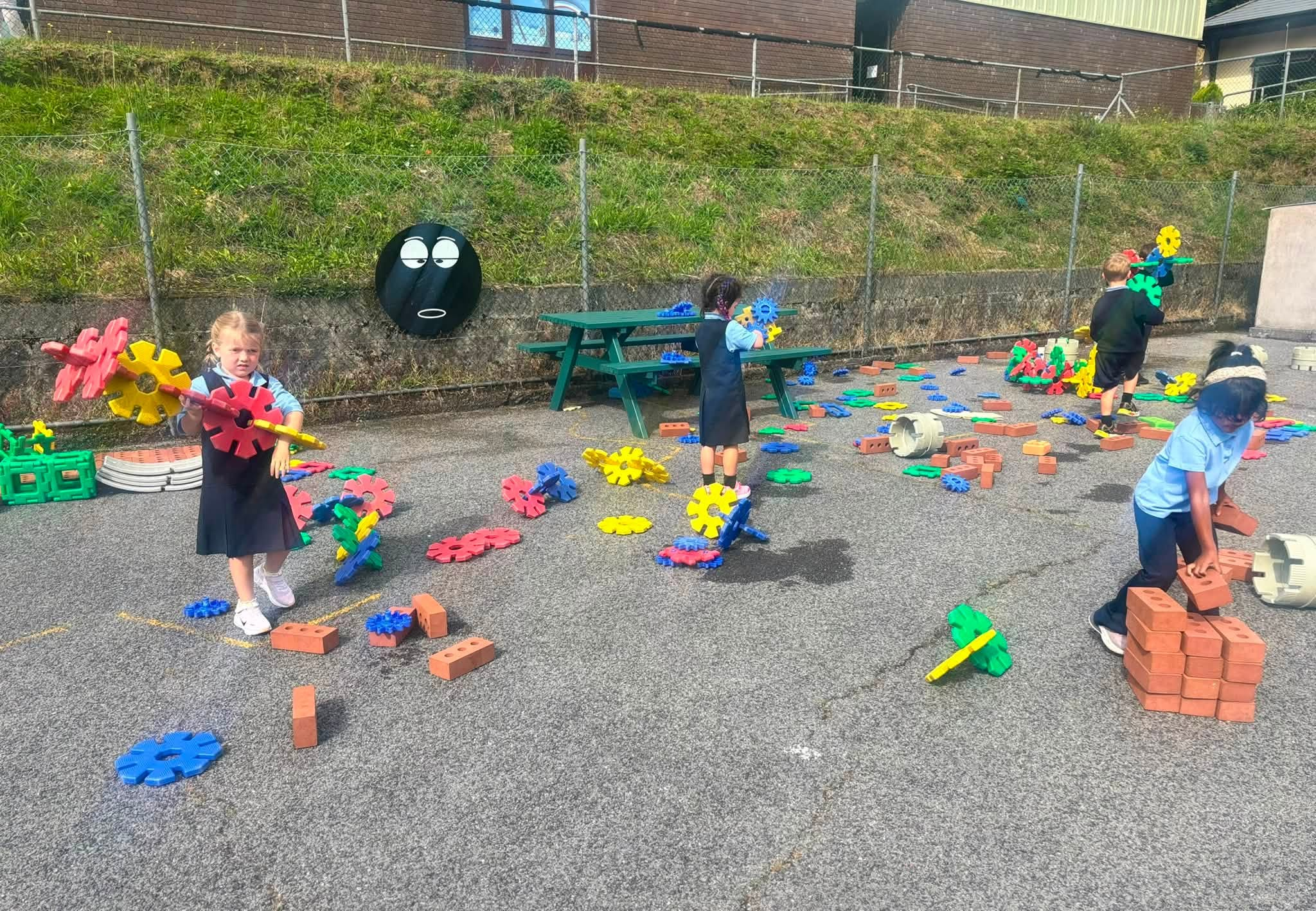 Junior Infants exploring colourful outdoor play equipment